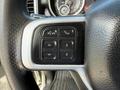 Close-up of the control panel on the steering wheel of a 2020 Ram 2500 featuring buttons for audio and call functions