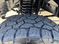 Close-up of a rugged tire with deep treads mounted on a 2018 RAM 3500 showcasing the sturdy construction and grip for off-road capability