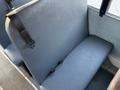 A gray vinyl seat of a 2014 International 4300 bus with a seatbelt clip visible on the side