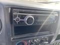 Close-up of the dashboard of a 2019 Hino 195 featuring a digital radio with Bluetooth capabilities and control knobs for volume and tuning