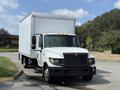 A white 2014 International TerraStar box truck with a large cargo area and black front grille is parked on a roadway