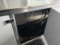 A 2020 Freightliner MT45 with an open compartment revealing electrical wires and plumbing connections under a stainless steel countertop