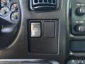 Control panel featuring two push buttons in a 2007 GMC C4500 TopKick interior with various gauges and controls visible around them
