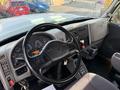 Interior view of a 2011 International 7500 truck dashboard featuring a steering wheel, gauges, controls, and a gear shift
