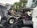 2013 Freightliner 114SD engine compartment showing various mechanical components including hoses and wires
