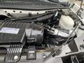 Engine compartment of a 2020 Chevrolet Express showing the air intake and various components including hoses and a reservoir