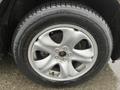 Close-up of a silver alloy wheel from a 2016 Subaru Forester featuring a multi-spoke design mounted on a Michelin tire