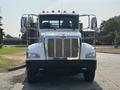 A 2020 Peterbilt 330 truck is shown from the front featuring a chrome grille and large side mirrors