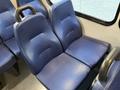 Two blue fabric seats with a textured surface inside a vehicle, designed for comfort and support
