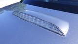 A polished silver 2007 Mazda Miata roof with a sleek aerodynamic design and a distinctive raised light fixture
