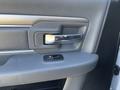 Close-up of the interior door handle and window control switch of a 2014 RAM 5500 truck