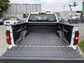 A 2016 GMC Sierra 1500 pickup truck with an empty bed view showing a black bed liner and the GMC logo in the center