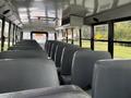 Interior view of a 2022 Freightliner B2 school bus featuring rows of grey vinyl seats and clear windows