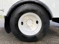 A close-up view of a tire mounted on a 2013 International Durastar 4300 featuring a white rim and the Goodyear brand name on the tire sidewall