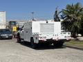 A 2017 Ford F-550 service truck with a white utility body and various equipment mounted on the back