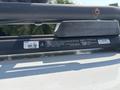 A 2017 Chevrolet Colorado with a roof rack and a label displaying weight and safety information