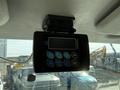 A digital display unit mounted on the ceiling of a vehicle with buttons for setting and programming various functions