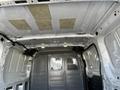 Interior view of a 2017 Ford Transit van showing the roof structure and partition wall with metal mesh panels