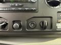 Dashboard controls of a 2011 Ford Econoline showing knobs and buttons for various functions and settings