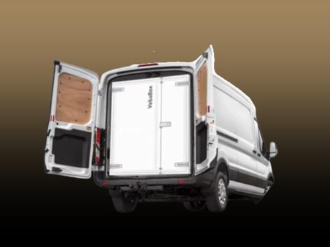 A 2025 Ford Transit van with open rear doors revealing an empty cargo area inside
