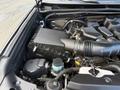 A close-up view of the engine compartment of a 2021 Toyota 4Runner showcasing various engine components including the air filter box and hoses