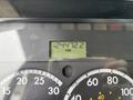 The dashboard of a 2013 Freightliner 114SD showing a digital odometer reading 12447.2 KM with analog gauges for speed and other metrics