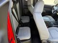 Interior view of a 2018 GMC Canyon showing two rear seats with gray upholstery and seatbelts