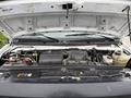 2024 Ford E-450 engine compartment with various components visible including the battery reservoir and cooling system parts