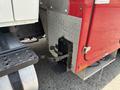 Close-up of a 2012 International 7300 Workstar's rear hitch setup featuring a black receiver with a mounting bracket and a metal plate with diamond pattern