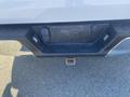 The rear view of a 2017 Ford F-150 showing the hitch receiver and two wiring harness connectors on the bumper
