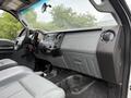 Interior view of a 2015 Ford F-350 SD featuring a gray dashboard with the text Super Duty and a center console with audio controls and air vents