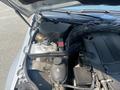 Close-up view of the engine bay of a 2013 Mercedes-Benz C-Class showing the battery the coolant reservoir and various engine components