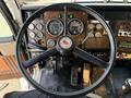 The steering wheel and dashboard of a 1996 Kenworth T800 featuring gauges and controls designed for heavy-duty trucking