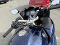 A 2016 Yamaha FJR1300AE motorcycle showing the handlebars, controls, and part of the fuel tank with a key and a key fob attached