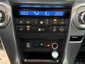 The console of a 2018 Toyota 4Runner displaying climate control buttons and knobs along with USB and auxiliary input ports