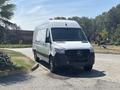 A 2019 Mercedes-Benz Sprinter van in silver with a black front grille and large rear cargo area parked on a driveway