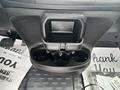 A cup holder and storage compartment in the front console of a 2023 RAM Promaster 3500