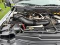 Close-up of the engine compartment of a 2018 Ford F-550 showcasing the air intake and engine components with visible battery and hoses