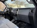 Interior of a 2015 Ford F-550 featuring a gray dashboard and seating with controls and a Super Duty emblem