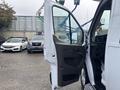 A 2021 Ford Transit-350 van with its driver's side door open showcasing the interior features and seating arrangement