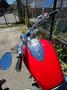A 2007 Honda VTX1800F3 motorcycle with a glossy red tank and chrome accents featuring handlebars with mirrors and controls.