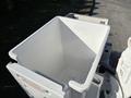 A white bucket mounted on a 2006 Freightliner M2 106 truck designed for utility work
