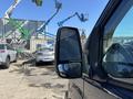 A 2016 Ford Transit 150 with a side mirror in focus showing a clear reflection
