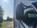 A close-up view of the side mirror of a 2018 Hino 195 truck with a reflective surface and a black housing