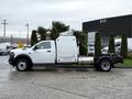 A 2024 RAM 5500 chassis cab truck in white with a flatbed design visible on one side and a prominent truck grille in the front