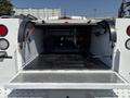 The image shows the open bed of a 2017 Chevrolet Colorado with a diamond plate floor and various tools and equipment visible inside