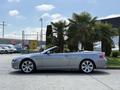 A silver 2004 BMW 6-Series convertible parked with its top down featuring a sleek design and five-spoke alloy wheels