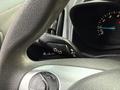 Close-up of the steering wheel and dashboard controls of a 2017 Ford Transit Connect showing turn signal and headlight adjustment switches