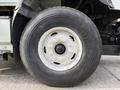 Close-up of a large tire from a 2016 International 7600 featuring a white rim and visible tread pattern