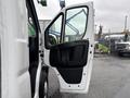 A 2023 RAM Promaster 3500 van with its side door open revealing the interior door handle and panel